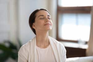Woman smiling and taking a deep breath