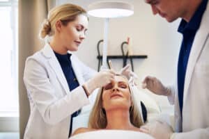Doctors consulting with a woman about her facelift procedure
